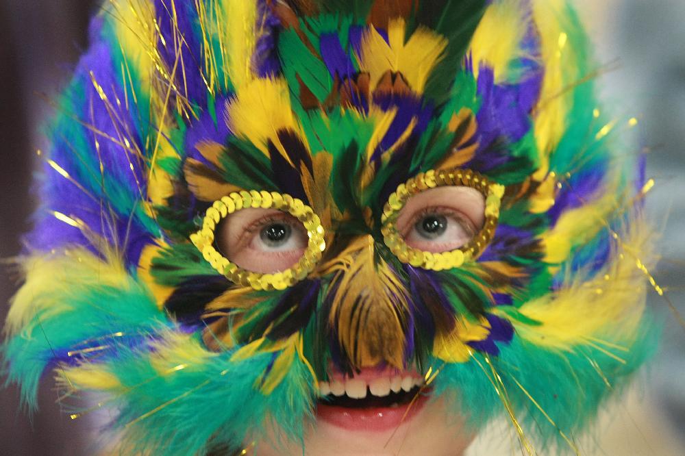 Arkansas Democrat-Gazette/RICK MCFARLAND--03/08/11-- Elizabeth James, 2nd grade, wears a colorful mask to the Mardi Gras Carnival at Our Lady of the Holy Souls Catholic Church in Little Rock Tuesday.