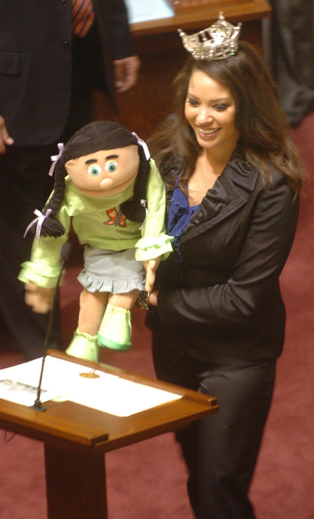 Arkansas Democrat-Gazette/STEVE KEESEE 3/8/11 Miss Arkansas Alyse Eady does her ventriloquist singing act with one of her puppets, Molly, Tuesday in the Senate chamber .