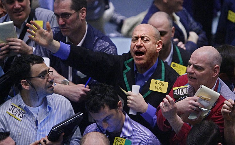 Traders of crude oil and natural gas engage in early trading Tuesday at the New York Mercantile Exchange. 