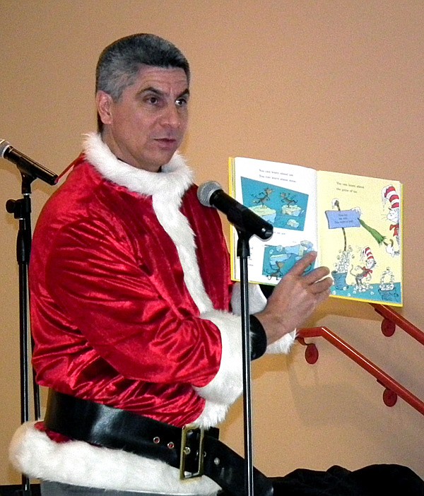 Superintendent Larry Ben, dressed as the Grinch, read a Dr. Seuss book to Decatur Northside Elementary students at a school assembly on Wednesday. Ben greeted children with a Grinch mask, but had to take his mask off to read the story. 