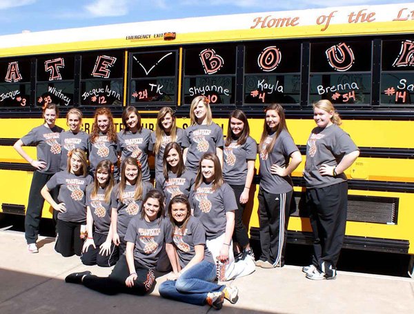 The sign on the bus, "State Bound" tells the story for Gravette's Lady Lions as they prepared to make the bus trip to Heber Springs after earning their first trip to state in ten years. Front row, from the left, Amanda White, Samantha Vanotterloo; second row, Shayenne Nichols, Jacqueline Kappel, Whitney DeWitt, Monica White and Jessica Bayley; back row, Destaney Wishon, Jacquelynn Janes, Kendra Meeker, Takara Waldrip, Shelby Newell, Kaitlyn Britton, Kayla Harrelson, Vanessa Moore and Brenna Sullivan.