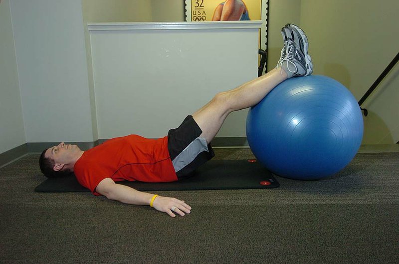 The Hamstring Hip Raise lets Ian Hadden work his hamstrings and gluteals without bending his knees, which can be a problem in the case of minor knee injuries. 