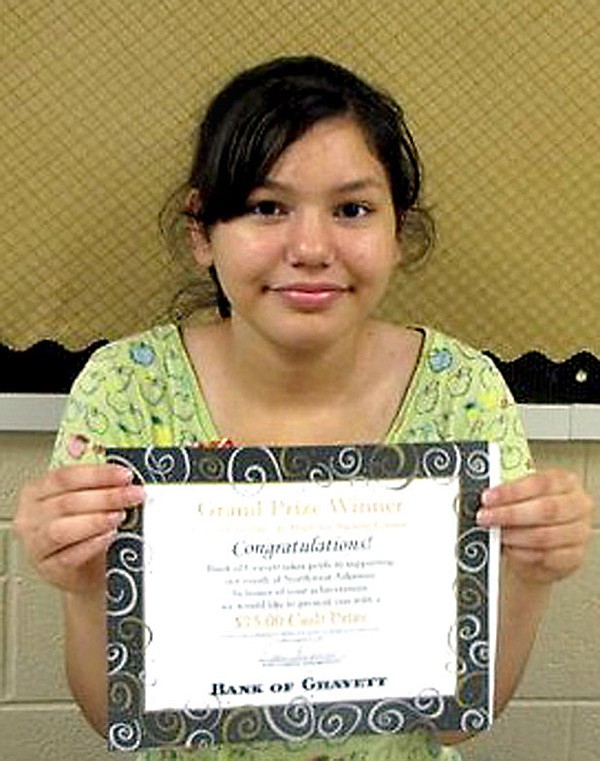 Cassandra Guerra holds a certificate she was awarded for her winning logo design for the City of Gravette. She also received a cash award from the Bank of Gravett.