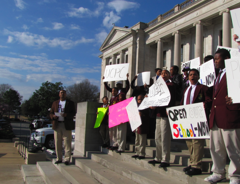 Parents and students from the shuttered Little Rock Urban Collegiate Public Charter School for Young Men rally at the State Capitol Wednesday in a bid to get the facility to reopen.