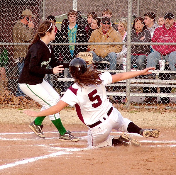Gentry junior Cloie Sikes slides across the plate well ahead of the throw from Greenland's catcher in the March 11 rescheduled game at Gentry.
