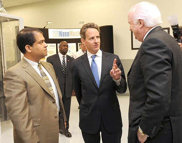 Treasury secretary Timothy Geithner, center, speaks Friday with James M. Phillips, CEO and chairman of NanoMech, right, and Ajay P. Malshe, NanoMech co-founder and chief technology officer, at the NanoMech facility in Springdale.