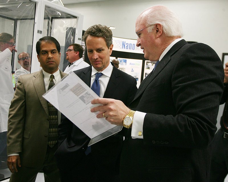 U.S. Treasury Secretary Timothy Geithner, flanked Friday by NanoMech executives Ajay Malshe (left) and Jim Phillips, gets a tour of the company’s Springdale facility. 