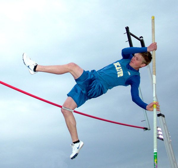 Decatur student Evan Owens pushes to get over the bar during pole vaulting competition at the Gravette Lion Invitational track meet on Monday. Decatur's team had few participants and finished with 5 points for the boys and 4 for the girls.