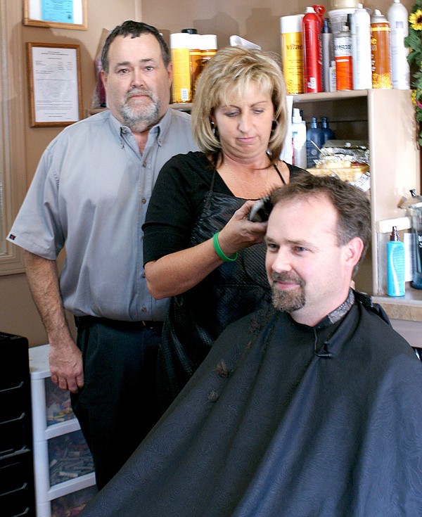 Zane Vanderpool, principal at Glenn Duffy Elementary School in Gravette, is ready as Michelle House at The Patio in Gravette readies her clippers.