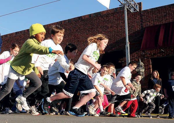 Runners leave the starting Saturday line for a children’s fun run in the Bentonville Running Festival. A half-marathon and a 5K were also part of the festival.