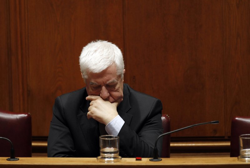 Portuguese Finance Minister Fernando Teixeira dos Santos reacts during the parliamentary debate on his minority government's latest austerity package Wednesday, March 23 2011, at the Portuguese parliament in Lisbon.