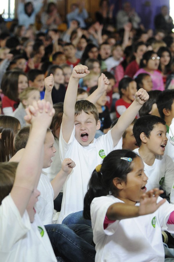 Cole Scott cheers Tuesday as it is announced Walker Elementary School has won the National Geographic “Find Your Footprint” video contest in Springdale. The video was created by second-graders at the school and expressed ways people can reduce their impact on the environment.