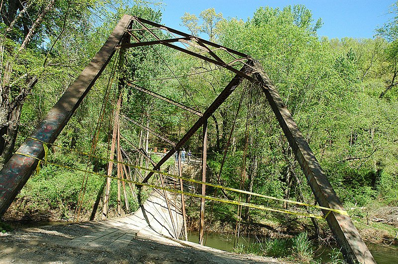  Yellow tape blocks an entrance to the historic Fryer Bridge, Tuesday, April 12, 2011, in Morrilton, Ark. The bridge collapsed after the driver of a 9-ton truck drove over the structure that has a 3-ton weight limit.  The Fryer Bridge is a metal truss that's one of the last of its kind in the state. The state highway commission says it's the oldest bridge that was still in service in Arkansas. 