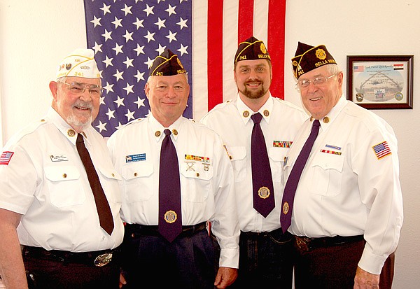 Bella Vista American Legion Post members Norvil Lantz (left), Lewis Kaslow, Chris Cole and post commander Jake Greeling posed for a photo in front of the U.S. Flag at their recent post meeting.