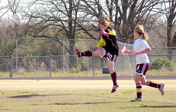 Gentry's goal keeper, Terra Jones, kicks one away during the team's April 5 game against Fayetteville. The girls lost 7-0 in the match up. Ashley Scott was there to help protect Gentry's goal.
