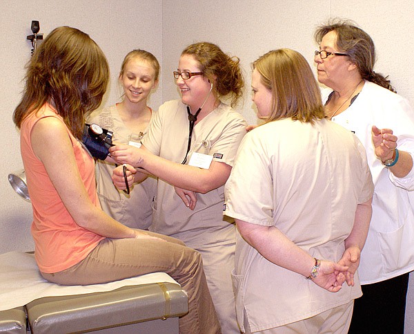 PCA student Kaitlin Holmes prepares to check blood pressure on OCH communications coordinator Jayna Cardetti Thursday while PCA students Tiffany Chandler, Elyssa Sheets and PCA instructor Lonnie Moll look on.
