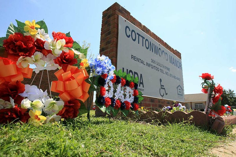   Arkansas Democrat-Gazette/fSTATON BREIDENTHAL 4/14/11
Flowers sit at the entrance to Cottonwood Manor Apartments in Trumann Thursday afternoon where Trumann police officer Jonathan Schmidt was fatally shot during a traffic stop Tuesday night. 
