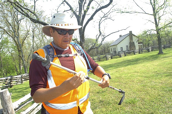 Ron Cooper gets his hiking staff ready Thursday to walk another section of the Trail of Tears, this one inside Pea Ridge National Military Park. Cooper, from Lawton, Okla., is nearing the end of his journey to hike the Trail of Tears from near Chattanooga, Tenn., to Tahlequah, Okla. Cooper began his quest Jan. 17 in Charleston, Tenn., and has walked 780 miles. Cooper plans to finish his walk Wednesday in Tahlequah.
