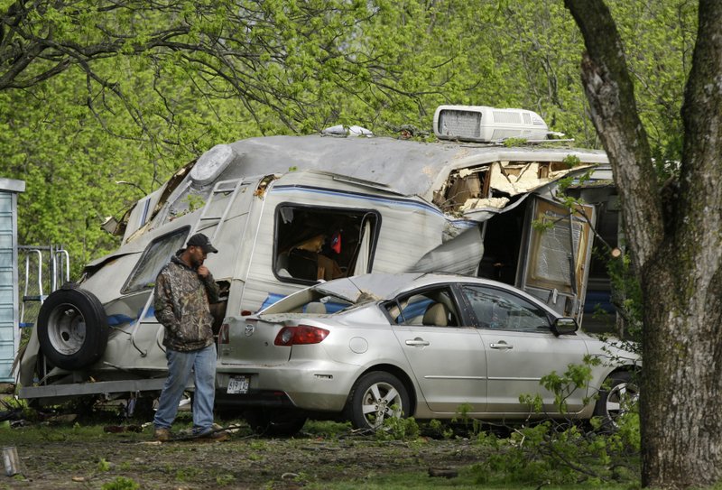 Donnie Spires walks near a recreational vehicle near Scott on Friday, April 15, 2011, where a 56-year-old man was killed when the RV collapsed on him during a severe storm. 
