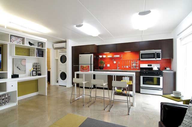 Sleek, open kitchen with concrete counters has custom-designed island.