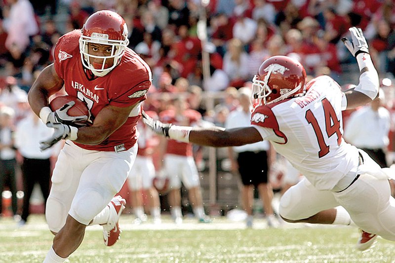 Red running back Knile Davis gets past White safety Eric Bennett toward the end zone for a touchdown during the third quarter of the Red-White Spring Game on Saturday, April 16, 2011, inside Donald W. Reynolds Razorback Stadium in Fayetteville.