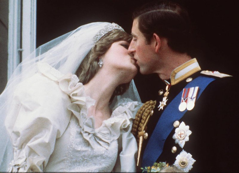  FILE--Britain's Prince Charles kisses his bride, the former Diana Spencer, on the balcony of London's Buckingham Palace following their wedding in this July 29, 1981, file photo. The couple's marriage was finally and officially ended Wednesday, Aug. 28, 1996. Fifteen years after the couple's "fairy-tale" wedding, watched on television by millions of people around the world, a legal clerk issued a decree that their divorce is now "absolute". 