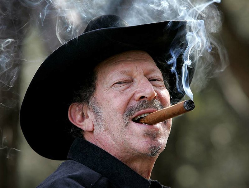  Musician and author Kinky Friedman smokes a cigar at his ranch near Medina, Texas, Friday, Jan. 21, 2005. Friedman plans to run for governor of Texas in 2006 and has scheduled his announcement for Thursday in front of the Alamo in San Antonio.  