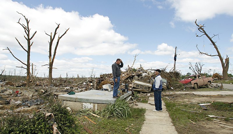  Billy Burns stands on his front porch talking to a neighbor after a tornado hit Pleasant Grove just west of downtown Birmingham yesterday afternoon on Thursday, April 28, 2011, in Birmingham, Ala.  