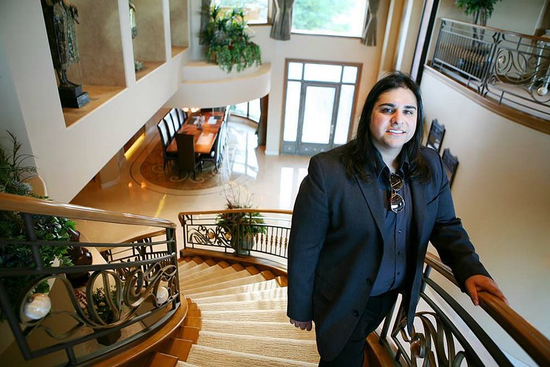  Zar Zanganeh, a realtor with Luxe Estates Collection, stands for a photograph in the foyer of a luxury home previously owned by actor Nicolas Cage in Las Vegas, Nevada, U.S., on Wednesday, April 20, 2011. A growing number of high-end homes are selling at a loss or facing repossession by lenders in Las Vegas, which already has the highest rate of foreclosure filings among large U.S. cities. Photographer: Ronda Churchill/Bloomberg Zar Zanganeh

