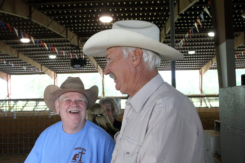  4/30/2011
Arkansas Democrat-Gazette/STEPHEN B. THORNTON
Destiny Cowboy Church pastor David Waltrip, left, talks with Leroy Anderson of Foothills Cowboy Church about Saturday's anniversary of the tornado which destroyed the Destiny church one year ago as they talk Saturday morning at a cowboy church rodeo at the Saline County Fairgrounds in Benton.