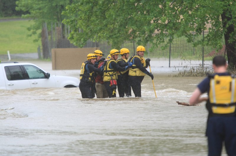 Little Rock firefighters rescue a stranded motorist from high water near the 12300 block of Interstate 30 on Monday morning.