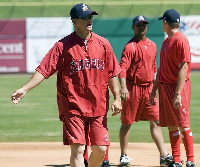 Bill Mosiello, far left, manager for the Arkansas Travlers works with some of the infielders during a recent workout session held at Dickey Stephens Park.