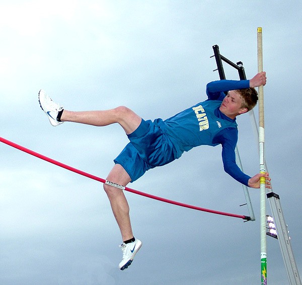 Decatur student Evan Owens pushes to get over the bar during pole vaulting competition at the Gravette Lion Invitational track meet on Monday. 
