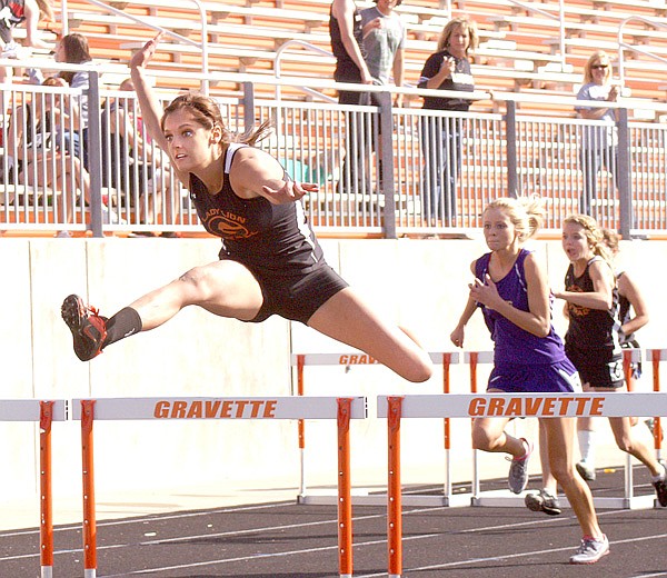 Hurdling to a first-place finish  — Gravette senior Taylor Kean clears a hurdle and is well ahead of her competitors in the 100-meter hurdles at the district track meet in Gravette on Thursday. She finished the event more than a second ahead of the second-place runner, with a time of 16.94. 
