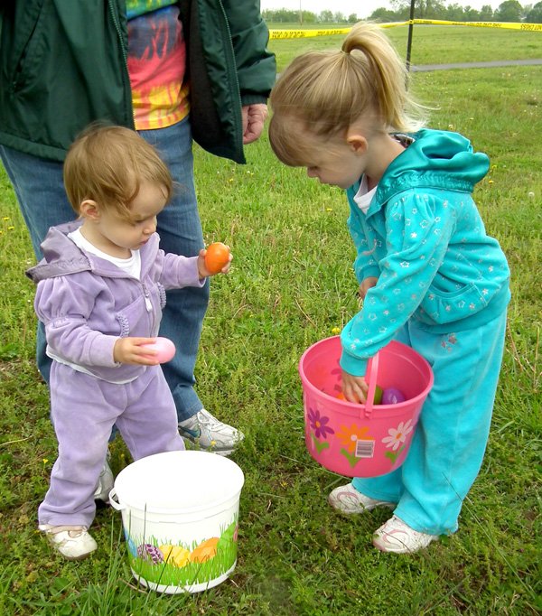 Sisters Emma and Mekena Dalke, ages 1 and 2, shared eggs after the Decatur Chamber of Commerce Egg Hunt held in Veteran's Park on Saturday morning. 