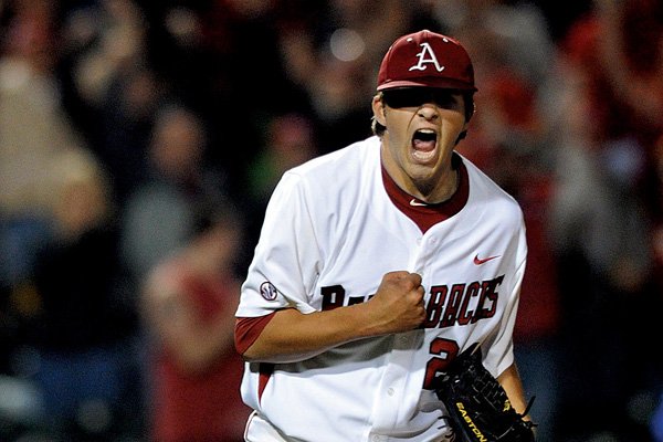 Arkansas pitcher DJ Baxendale pumps his fist and yells in celebration after pitching the Razorbacks to a complete game 4-3 victory over Florida on Thursday at Baum Stadium in Fayetteville. Baxendale allowed 7 hits, struck out 7 and walked 1 while throwing 127 pitches. 