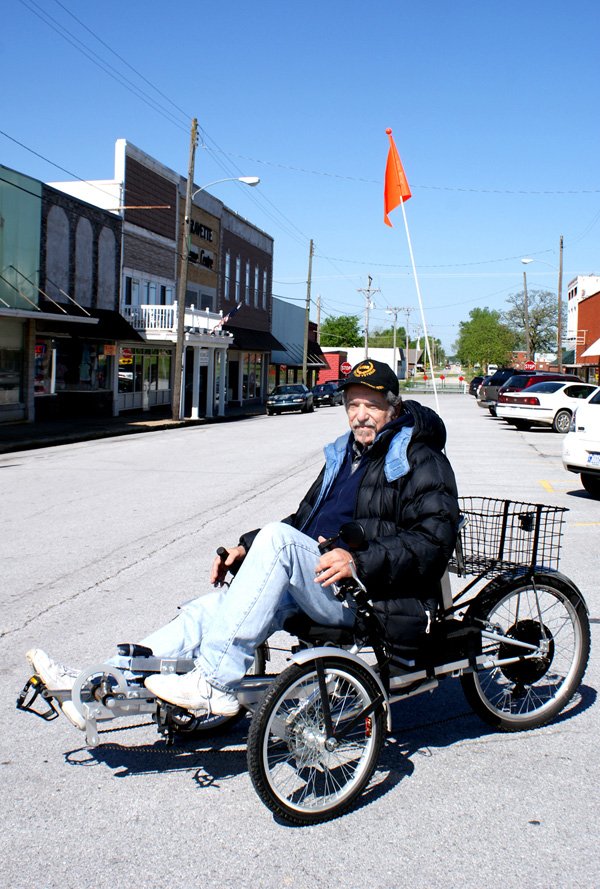 Don Justice and his three-wheel "Eco-bike" on Gravette Main Street. 