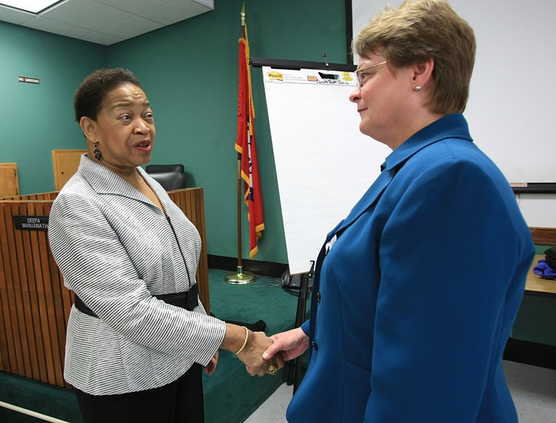 June Rimmer (left) talks with senior executive assistant Beverly Griffin Monday morning while meeting with district staff members. Rimmer is the sole finalist for the Little Rock School District Superintendent job.