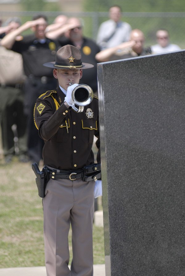 Matt Van Winkle, a member of the Arkansas Sheriffs’ Association Honor Guard, participates Monday in the unveiling of the Fallen Officer Memorial at the White County Law Enforcement Center in Searcy.