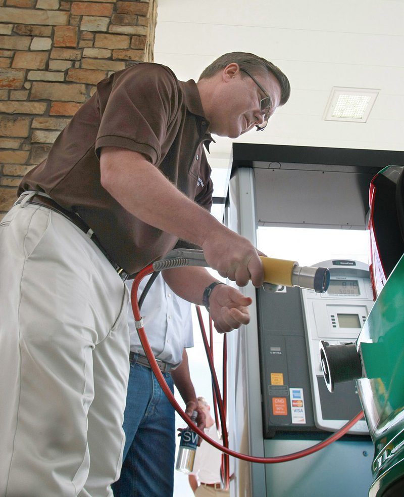  Arkansas Democrat-Gazette/RICK MCFARLAND - 05/13/11- Walter Bryant, president of Region 1 for CenterPoint Energy, finishes filling  the first car to use the Southwestern Energy natural gas station in Damascus Friday.
