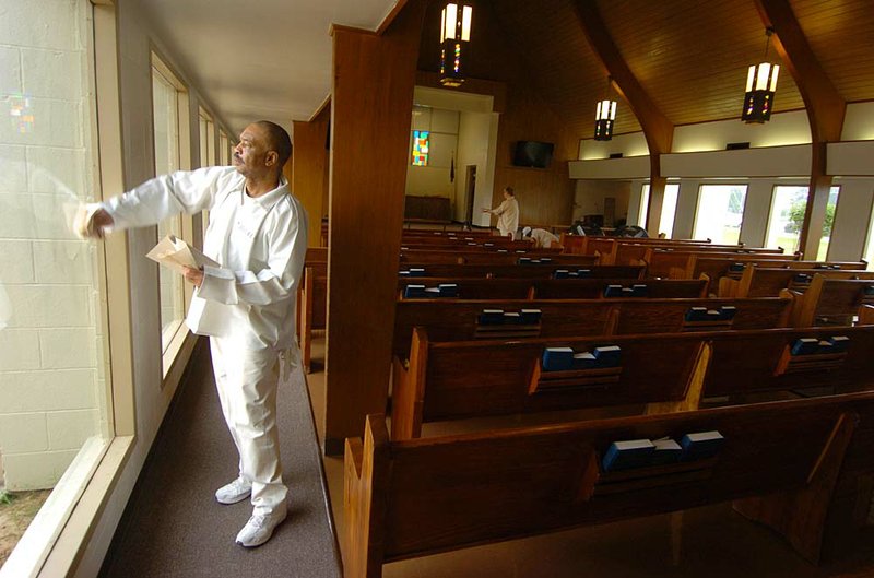 Tucker Unit inmate Michael Turner helps put the final touches on the prison’s Island of Hope Chapel for Friday’s rededication ceremony. 