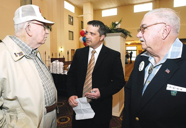Kelley Cradduck, center, talks to Allen Baker, left, and Elmer Crumbliss, both of Rogers, during a reception Saturday to announce his candidacy for Benton County sheriff at the Clarion Hotel & Convention Center in Bentonville.