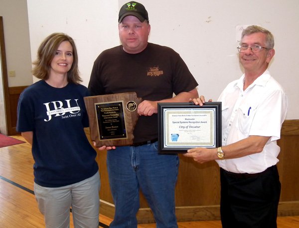 James Boston and the awards he received in Hot Springs, with his wife Jaymey Boston and mayor Charles Linam,.
