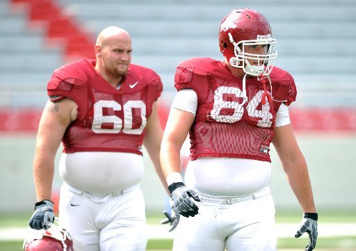 Arkansas Democrat-Gazette/MICHAEL WOODS - 08-24-10 - Travis Swanson (right) and Seth Oxner take a break during a preseason practice last August. Oxner said Wednesday he will transfer from the Razorbacks program. 