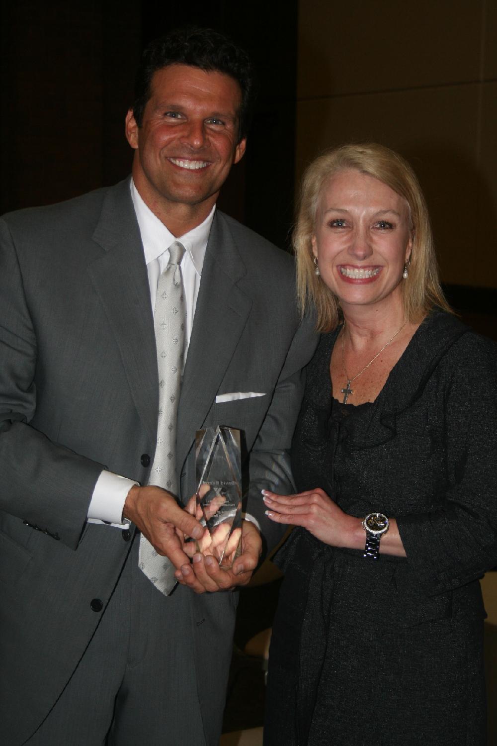 David Bazzel, holding his award, and event chairman Rachel Kremer