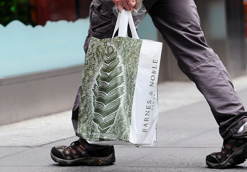  A man carries a Barnes & Noble shopping bag along Fifth Avenue in New York, U.S.