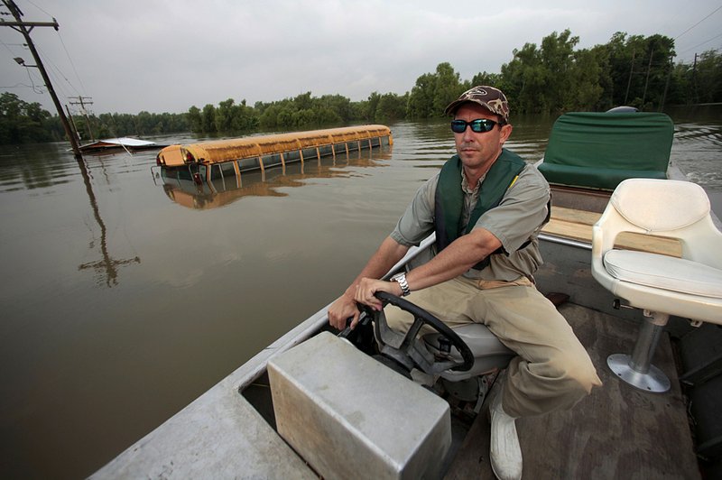 Alderman Robert Leake maneuvers through Mississippi River floodwaters Friday in St. Francisville, La., where residents face a mandatory evacuation order. 