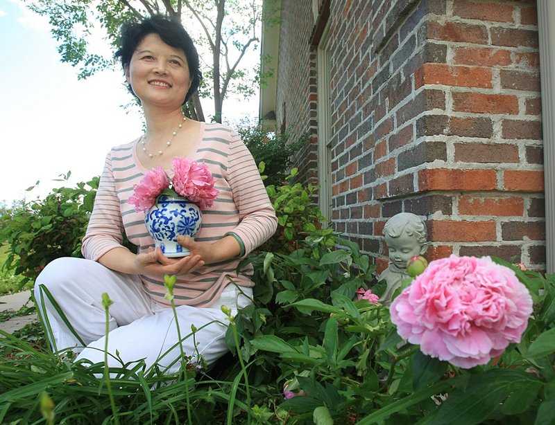 Arkansas Democrat-Gazette/STATON BREIDENTHAL  4/27/11
Dr. Qiaoli Lei in her favorite space at her Little Rock home.