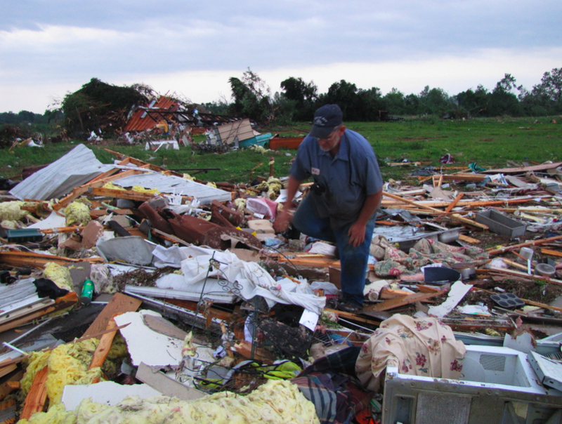 Hugh Ritter, 57, looks through the ruins of his trailer Wednesday morning hours after it was destroyed by a tornado.