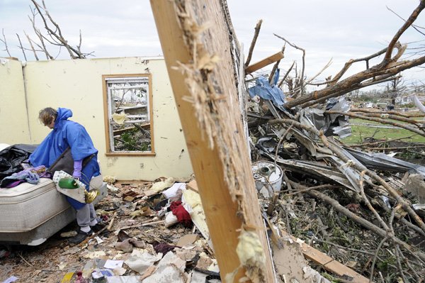 Mary Wier goes back to searching for belongings in the remains of her tornado-damaged home Wednesday after receiving food, water and toiletry items from volunteers of 3 Bags in 2 Days in Joplin, Mo. Wier said she survived the tornado by taking shelter in her bedroom closet. Several of Wier’s neighbors were killed by the tornado.